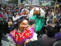 Lion dance plays with a child
