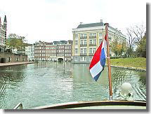 Boat with the national flag goes after the guest house and Hotel Europe.